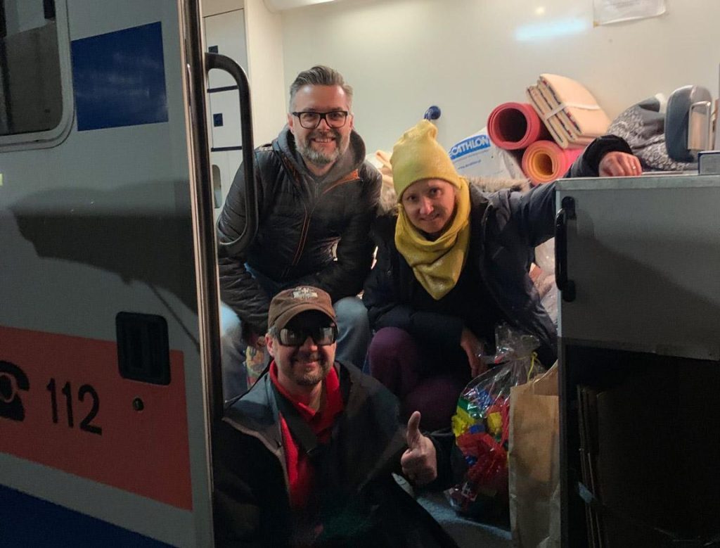 Volunteers in an aid vehicle with delivered supplies in Ukraine