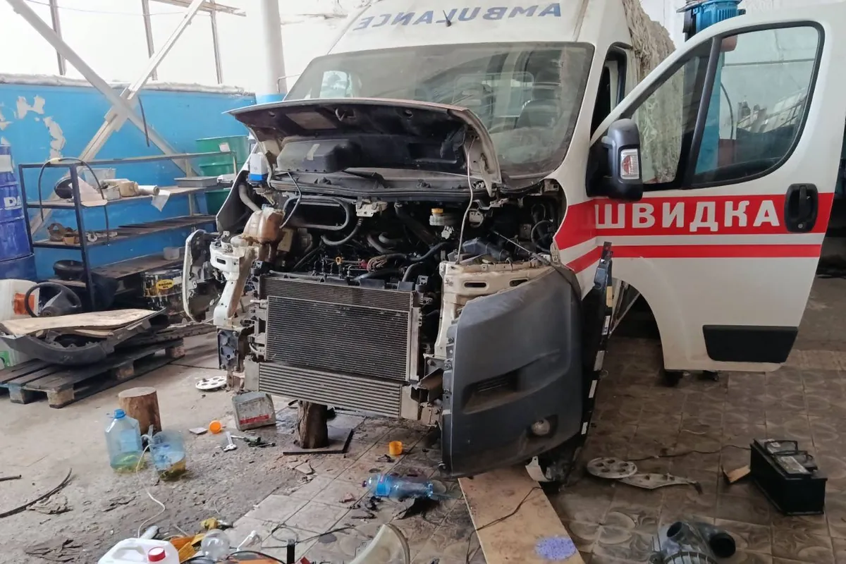 An ambulance under repair in a workshop